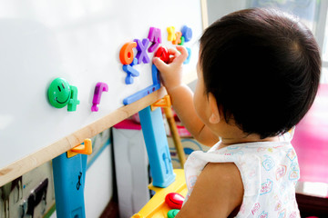 2 year old Thai children learn numbers on the board