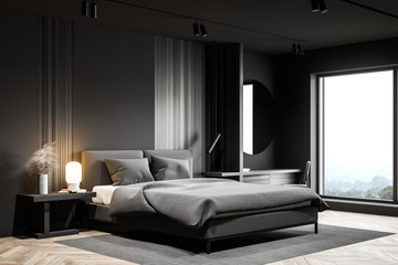 Gray bedroom corner with round mirror