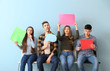 © Pixel-Shot - Group of young people with blank speech bubbles on color background