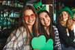 Young women celebrating St. Patrick's Day in pub