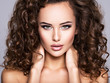 © Valua Vitaly - Woman with long bown curly hair