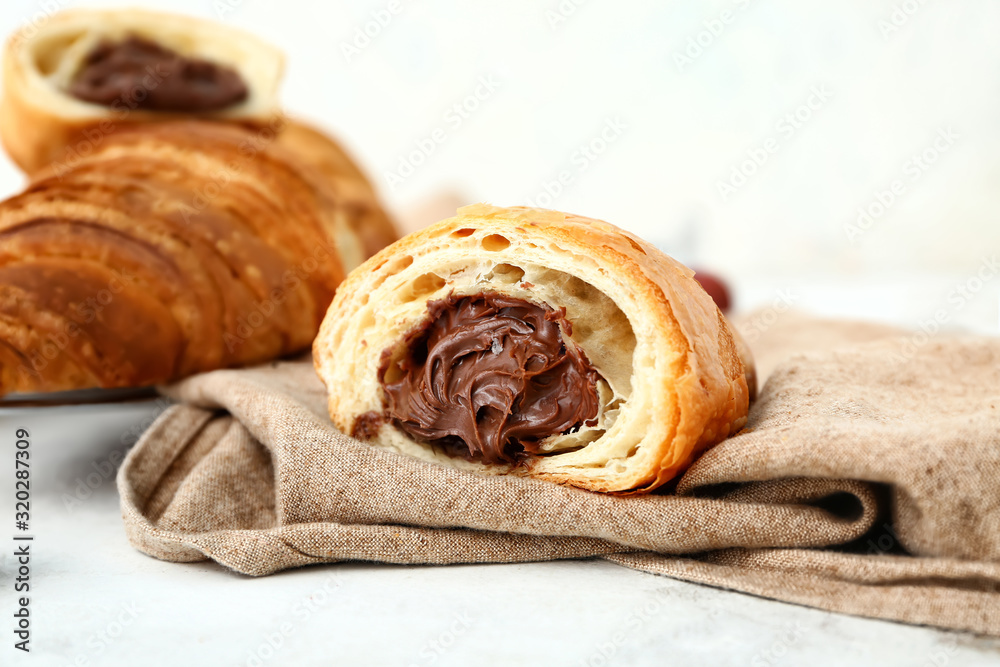 Tasty sweet croissant on white background