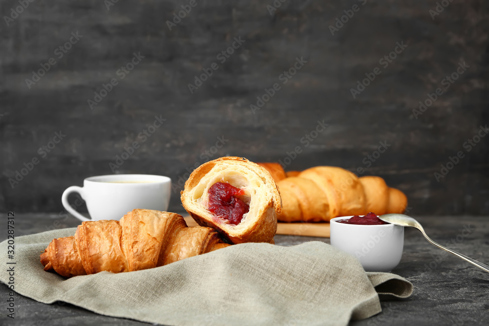 Tasty sweet croissants on grunge background