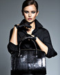 © Valua Vitaly - Beautiful woman in black  holds fashion handbag