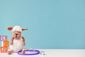 stethoscope and baby toy on table