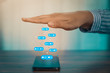 © RoBird - Person using a social media marketing concept on mobile phone with notification icons of like, message, comment and star above smartphone screen.