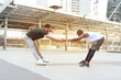 © Stella - Partner buddy runner men help each other stretching body before exercise run outdoor, jogger athlete training and doing workout in downtown city.
