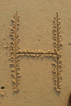 Letter H on the sand