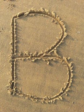 Letter B written on the beach 