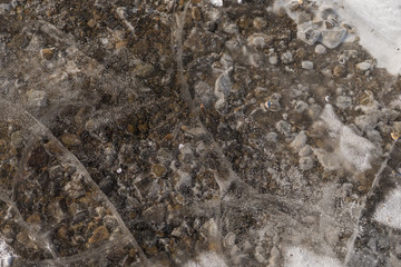 Wall Mural - The texture of the rocky bottom and a layer of ice