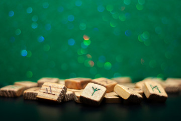 Group of old wooden runes on a green bokeh background