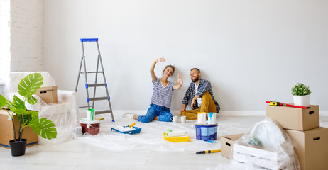 Wall Mural - young happy family married couple dreams of renovating  house and planning  design project.