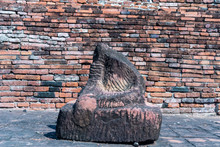 Old Sand Stone Buddha Image Statuie And Old Brick Wall Of Temple
