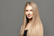 © Beauty Agent Studio - Beautiful young woman with long healthy hair posing against grey background. Beauty salon concept