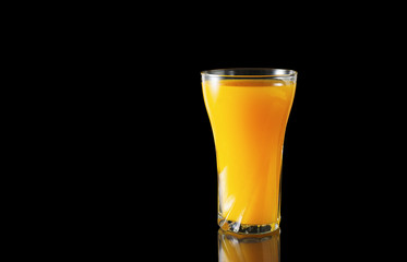 Wall Mural - Orange juice glass on a black background