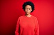© Krakenimages.com - Young beautiful African American afro woman with curly hair wearing casual sweater Relaxed with serious expression on face. Simple and natural looking at the camera.