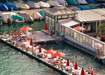 Canvas Print - Women beach at Limmat River quay in the city center of Zurich, Switzerland. Mixed media.