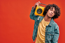 Young Man With Vintage Beat Box On Isolated Red Background