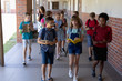 © wavebreak3 - Group of school pupils walking in an outdoor corridor at elementary school