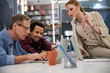 © Yakobchuk Olena - Company employees watching something on modern laptop