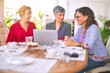 © Krakenimages.com - Meeting of middle age women having lunch and drinking coffee. Mature friends smiling happy using laptop at home on a sunny day