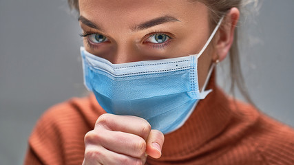 Wall Mural - Sick unhealthy coughing woman using blue medical protective mask to protecting others during flu virus outbreak and infectious diseases