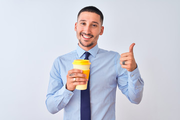 Young business man holding take away coffee over isolated background happy with big smile doing ok sign, thumb up with fingers, excellent sign