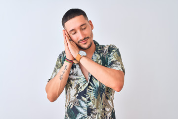 Wall Mural - Young handsome man wearing Hawaiian summer shirt over isolated background sleeping tired dreaming and posing with hands together while smiling with closed eyes.