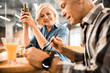 © Yakobchuk Olena - Smiling mature man eating lunch while sitting with wife