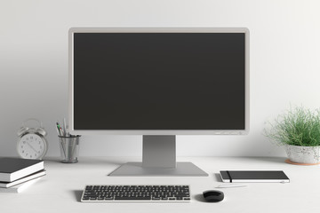 Workspace with blank computer monitor black screen mock up on the white desk near white wall. monitor; screen; computer; mock up;