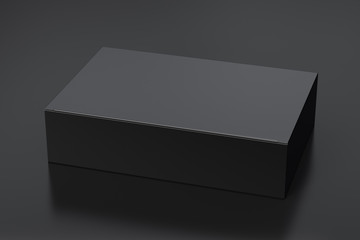 blank black wide flat box with closed hinged flap lid on black background. clipping path around box 
