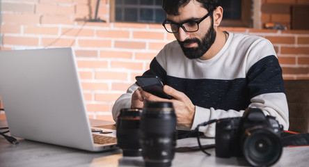 Poster - photographer man hand phone with lens on desk