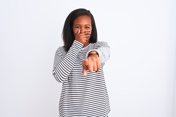 Beautiful young african american woman wearing winter sweater over isolated background laughing at you, pointing finger to the camera with hand over mouth, shame expression