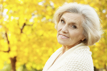 Wall Mural - Close up portrait of senior woman in autumn