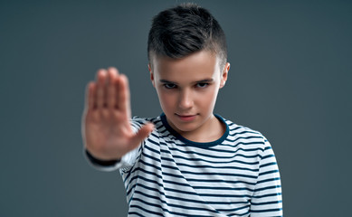 Fashionable boy on a gray background