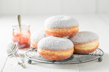 Closeup Of Tasty Donuts With Powdered Sugar On White Table