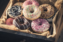 Closeup Of Tasty Donuts In Old Wooden Boxes