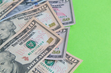 Banknotes Of American Dollars On A Green Background