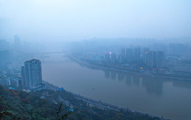 Chongqing River View.  Tall buildings on both sides of the river.  View of the business district.  Cityscape.  Overlooking the river from the mountain