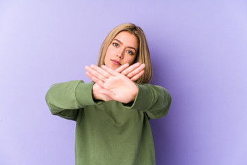 Young blonde caucasian woman isolated doing a denial gesture