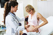 © hedgehog94 - Gynecology examination and consultation. Pregnant woman with her doctor at clinic.