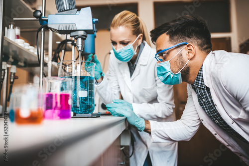 Cuadros en Lienzo Two middle age scientists and researchers work in chemical laboratory