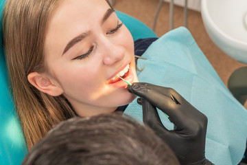 Wall Mural - doctor treats a patient tooth