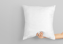 Woman Hand Holding White Blank Square Pillow Mockup On Isolated Background