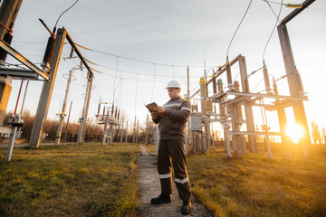 The energy engineer inspects the equipment of the substation. Power engineering. Industry