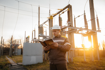 The energy engineer inspects the equipment of the substation. Power engineering. Industry