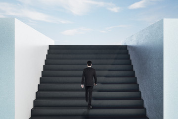 Canvas Print - Businessman walking on top ladder