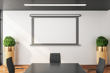 Blank screen for projector on wall in modern  meeting room