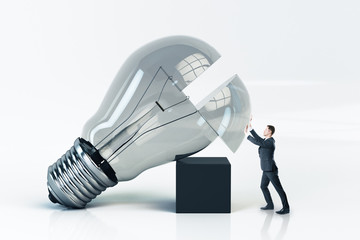Poster - Businessman pushes a big light bulb.