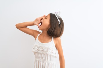 Wall Mural - Beautiful child girl wearing princess crown standing over isolated white background shouting and screaming loud to side with hand on mouth. Communication concept.